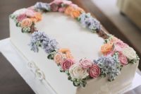 a beautiful sheet wedding cake topped with pastel sugar blooms and greenery is a delicious solution for a wedding filled with blooms