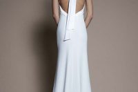 a beautiful silk halter neckline wedding dress with an open back and a scarf to accent this back is ultimately elegant