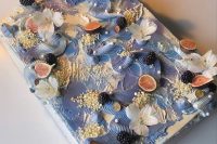 a blue swirl sheet wedding cake topped with fresh blackberries and figs plus orchids is a lovely idea for a coastal wedding