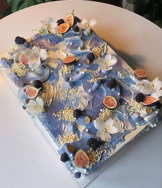 a blue swirl sheet wedding cake topped with fresh blackberries and figs plus orchids is a lovely idea for a coastal wedding