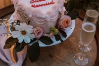 a blush heart-shaped wedding cake with red calligraphy and sugar detailing is a lovely vintage-inspired idea