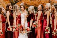 a bridal party in the shades of orange, red and burgundy is a gorgeous solution for a bright fall wedding