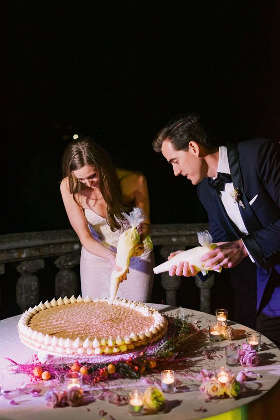 a classic millefoglie topped with meringues and the couple writing some words on it for the guests