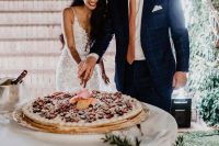 a classy millefoglie wedding cake topped with pink roses and fresh berries is a great idea if you love Italian food and desserts