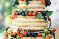 a cool fall millefoglie wedding cake tiered and topped with fresh graoes, apricots, cherries and pears is amazing