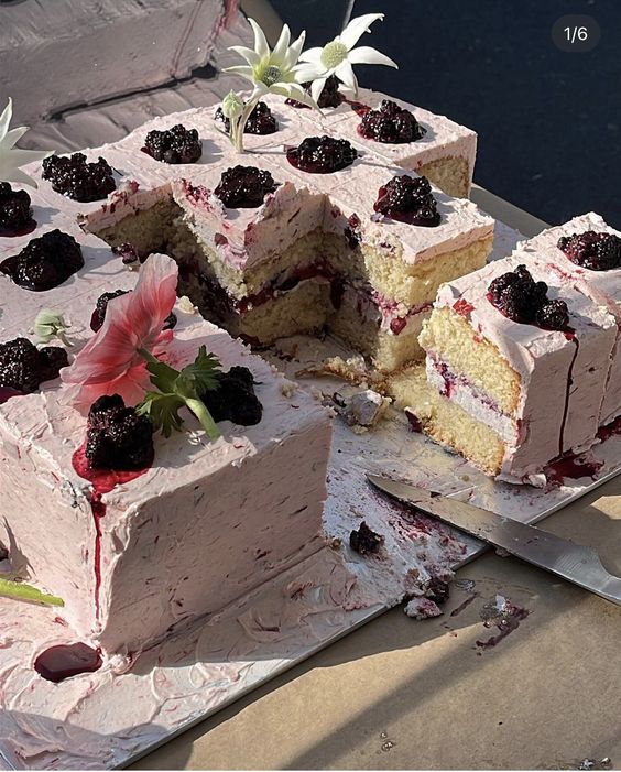 a cool sheet wedding cake topped with blooms and berry compote is ideal and delicious for a summer wedding