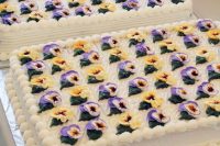a duo of lovely sheet wedding cakes topped with pansies is a lovely solution for a spring or summer garden wedding