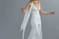 a fitting strap silk wedding dress with a depe neckline and a scarf for a flowy and ultra-modern bridal look