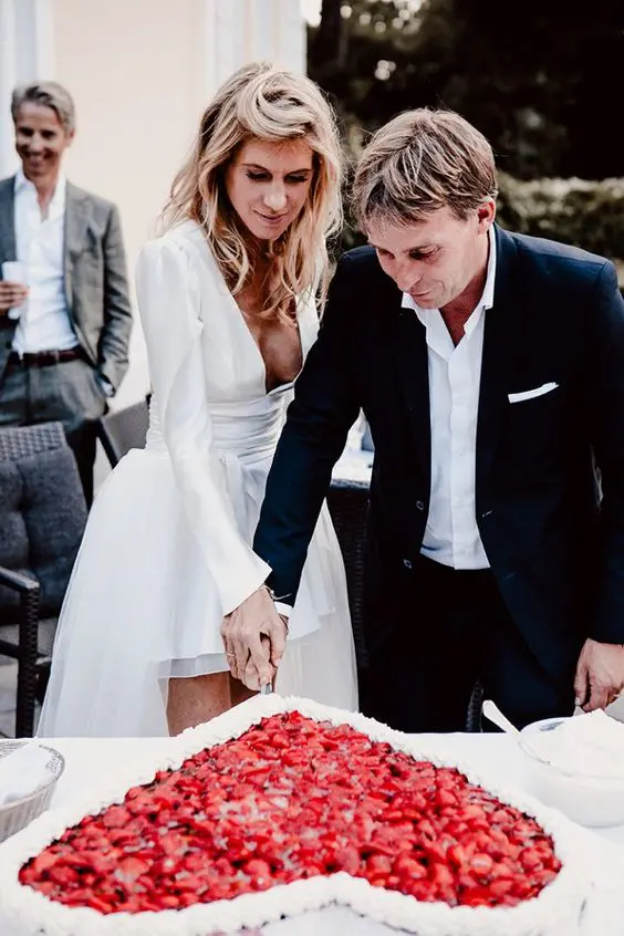 a gorgeous heart-shaped millefoglie wedding cake topped with meringues and fresh strawberries is ultimate