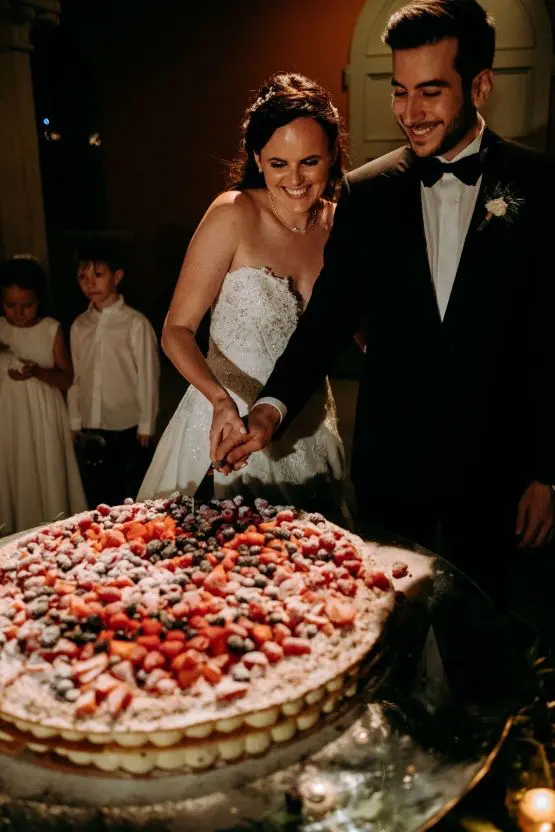 a gorgeous millefoglie wedding cake topped with fresh berries and sugar powder is classics of Italian cuisine and is adorable