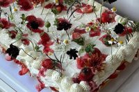 a gorgeous sheet wedding cake topped with fresh berries and blooms is a lovely idea for a modern garden wedding