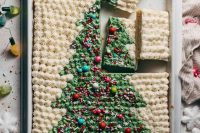 a gorgeous sheet wedding cake with a Christmas tree painted on top and colorful beads is adorable for a Christmas wedding