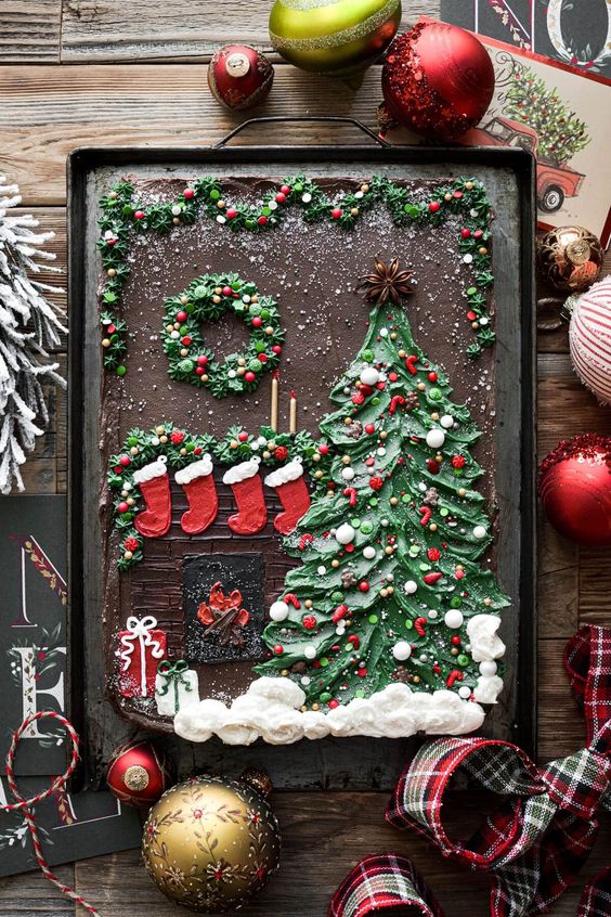 a jaw-dropping Christmas tree sheet cake with a tree, a fireplace and stockings painted with icing on top for a Christmas wedding