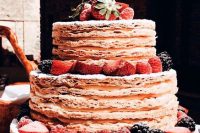 a jaw-dropping millefoglie styled as a usual tiered wedding cake, topped with berries and a calligraphy cake topper
