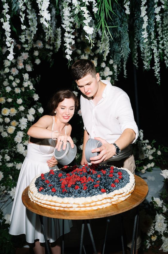 a jaw-dropping round millefoglie wedding cake topped with lots of fresh berries is a delicious dessert for every wedding