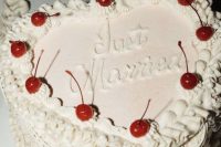 a lambeth heart-shaped wedding cake with some sugar details and some cherries on top is a cool idea