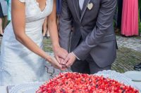 a large heart-shaped wedding cake topped with fresh berries is a very cool and delicious idea for a summer wedding
