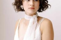 a lovely sheer pearl bridal scarf will give you a cute and lovely look, style it with a plain wedding dress