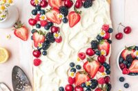 a lovely sheet wedding cake topped with fresh berries and some blooms is a cool idea for a summer wedding