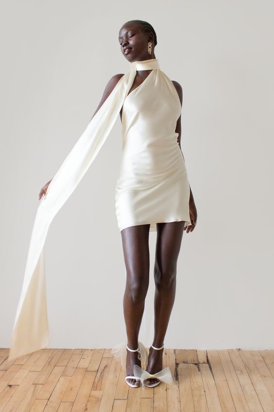 a modern short one shoulder wedding dress, bow shoes and a scarf to create a super trendy bridal look