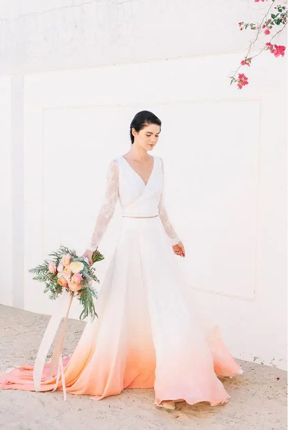 a neutral wedding dress with an ombre peachy skirt from orange to peachy pink is a cool statement