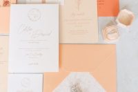 a peach and orange wedding stationery suite with prints and calligraphy is a cool and catchy idea for a bold wedding