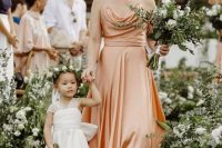 a peachy A-line bridesmaid dress with a cowl bodice and spaghetti straps is a refined and chic option