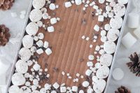 a rich red velvet sheet wedding cake with hot chocolate buttercream topped with marshmallows and chocolate curls for a winter wedding