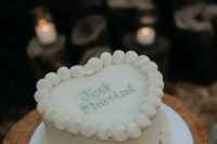 a simple white lambeth wedding cake with mint calligraphy is a cool idea for a modern wedding