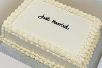 a small sheet wedding cake decorated with icing and black calligraphy is a perfect solution for a small wedding
