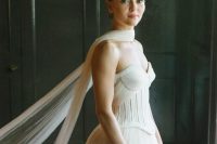 a sophisticated strapless wedding dress with a corset and a dreamy flowy scarf as a chic accessory for a wedding