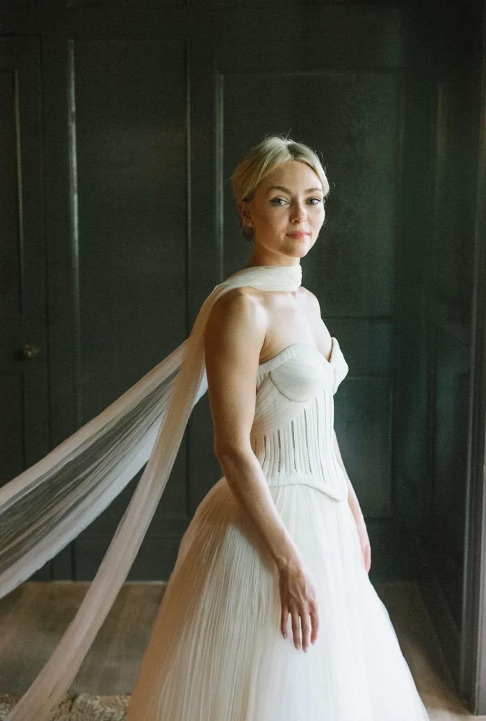 a sophisticated strapless wedding dress with a corset and a dreamy flowy scarf as a chic accessory for a wedding