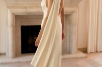 a stunning and elegant bridal look with a silk halter neckline wedding dress with a train and a scarf is inspired by the 90s