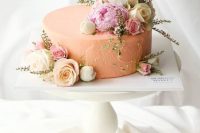 a textural peachy wedding cake decorated with pink and white flowers and greenery is amazing for a spring wedding