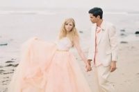 a unique wedding separate with a peachy pink layered full skirt and a neutral strapless top