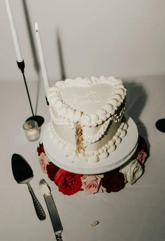 a white heart-shaped lambeth wedding cake with calligraphy is a lovely idea for a modern glam wedding