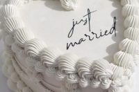 a white lambeth wedding cake with sugar detailing and black calligraphy is a cool idea for a modern wedding