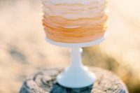 an ombre ruffle wedding cake from white to peachy pink is a beautiful idea for a spring or summer wedding