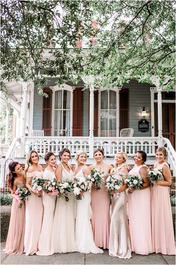 blush and pale pink maxi bridesmaid dresses with mismatching necklines are great for a spring wedding