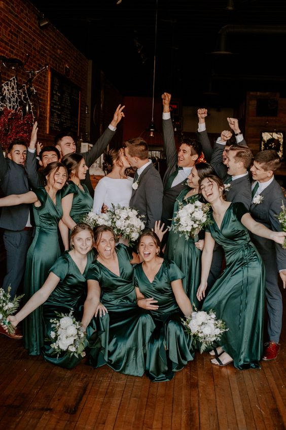 bold green midi wrap bridesmaid dresses paired with black shoes are amazing for a wedding with green in the color palette