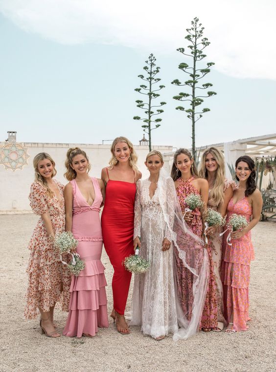 bridesmaid wearing pink floral midi and maxi dresses and the maid of honr rocking a deep red maxi dress