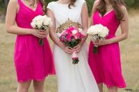 bridesmaids wearing hot pink knee bridesmaid dresses with draped bodices and thick straps plus black shoes look nice and bold