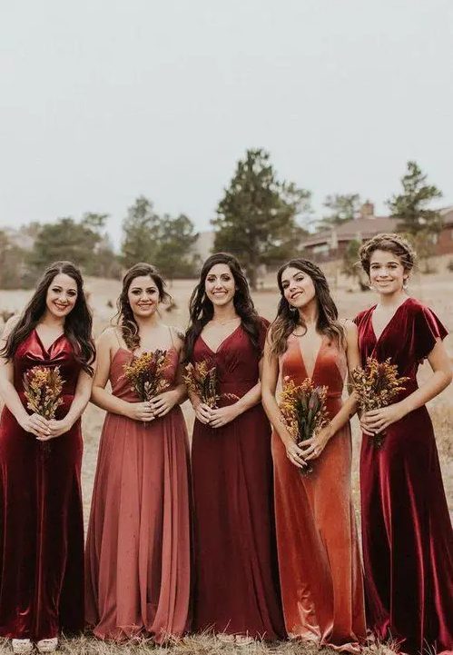 burgundy, deep red, dusty pink and orange velvet and cotton bridesmaid dresses with pleated skirts and various necklines