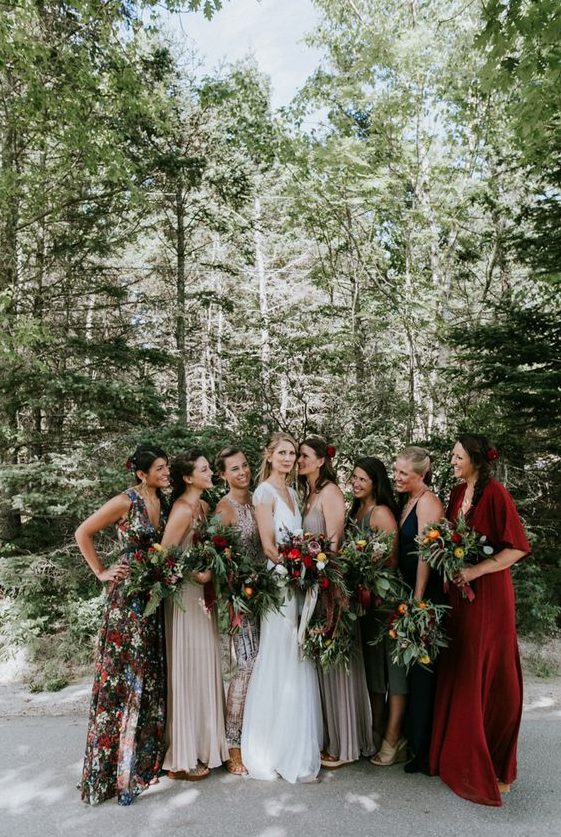 chic mismatched bridesmaids' maxi dresses with a floral print, in bold red, neutrals and dark shades