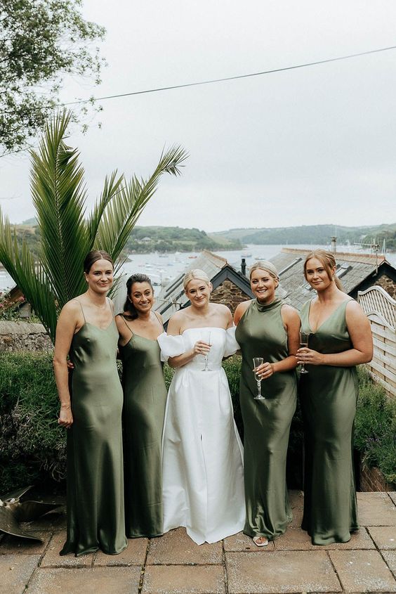 classy mismatching green bridesmaid dresses with mismatching necklines are great for a tropical wedding