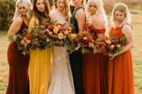 colorful and mismatching maxi bridesmaid dresses in burgundy, orange, rust, mustard and dark green for a fall wedding