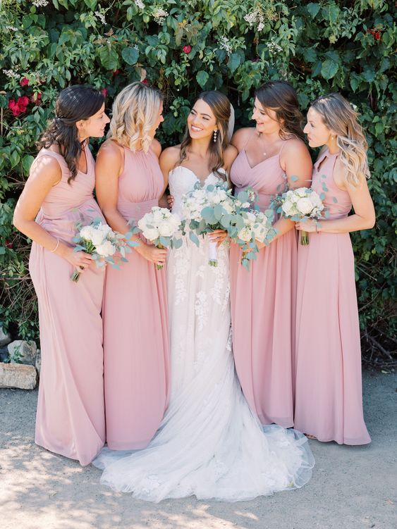 delicate maxi blush bridesmaid dresses with draping and pleated skirts are amazing for a spring or summer wedding