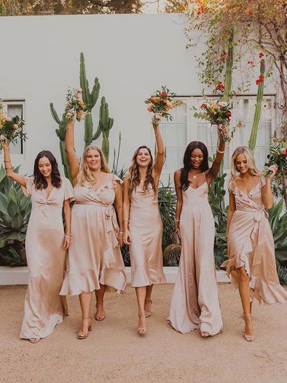 delicate mismatching satin blush midi and maxi bridesmaid dresses are great for a spring or summer wedding