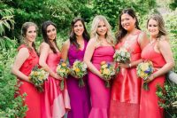 jaw-dropping purple and red mismatching bridesmaid outfits, dresses and a jumpsuit, for a colorful wedding