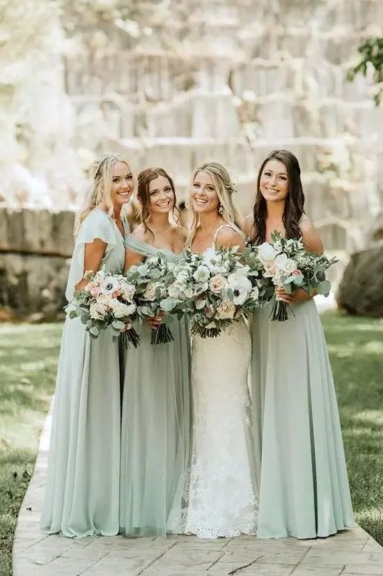 lovely sage green maxi bridesmaid dresses with mismatching necklines are amazing for a spring or summer wedding